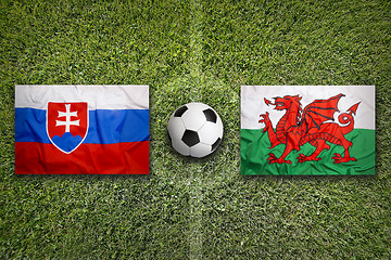 Image showing Slovakia vs. Wales flags on soccer field