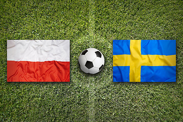 Image showing Poland vs. Sweden flags on soccer field