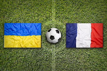 Image showing Ukraine vs. France flags on soccer field