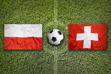 Image showing Poland vs. Switzerland flags on soccer field