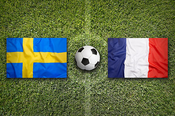 Image showing Sweden vs. France flags on soccer field