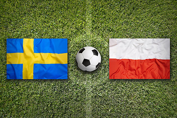 Image showing Sweden vs. Poland flags on soccer field