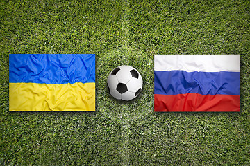 Image showing Ukraine vs. Russia flags on soccer field