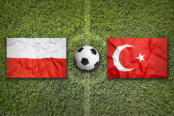 Image showing Poland vs. Turkey flags on soccer field