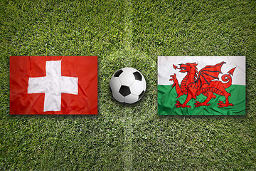 Image showing Switzerland vs. Wales flags on soccer field