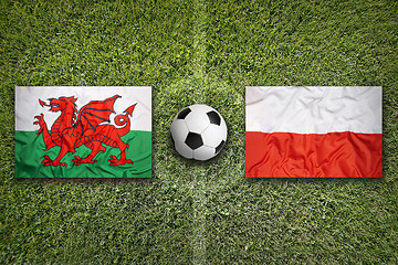 Image showing Wales vs. Poland flags on soccer field