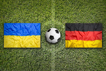 Image showing Ukraine vs. Germany flags on soccer field