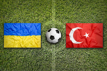 Image showing Ukraine vs. Turkey flags on soccer field