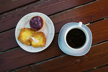 Image showing Coffee and pastry on a rustic table