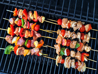 Image showing Meat and vegetable skewers on a grill