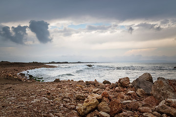 Image showing Dark sky, rocky coast and stormy sea