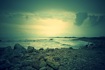 Image showing Gloomy rocky coast and stormy sea