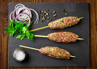 Image showing raw minced meat skewers kebabs