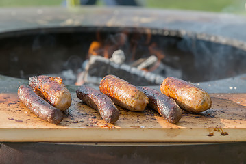 Image showing Grilling sausages on barbecue grill