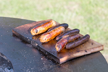 Image showing Grilling sausages on barbecue grill