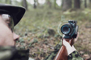 Image showing close up of soldier or sniper with gun in forest