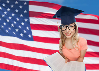 Image showing student woman in mortarboard with encyclopedia