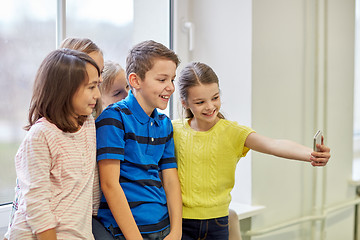 Image showing group of school kids taking selfie with smartphone