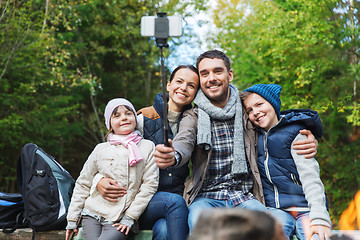 Image showing family with smartphone taking selfie near campfire