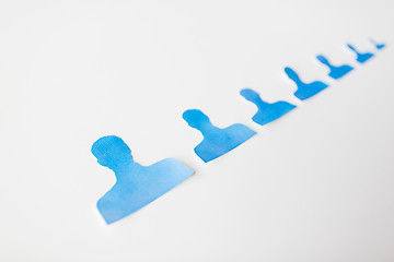 Image showing close up of paper human shapes on white board