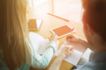 Image showing students with tablet pc writing to notebooks