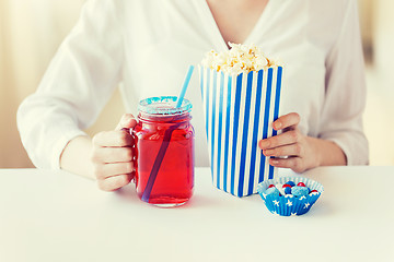 Image showing woman with popcorn and drink in glass mason jar