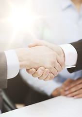 Image showing two businessmen shaking hands in office