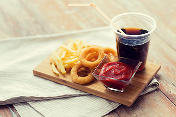 Image showing close up of fast food snacks and drink on table