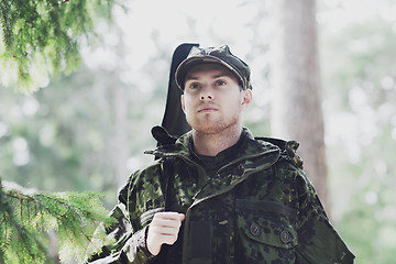 Image showing young soldier or hunter with gun in forest