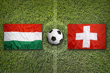 Image showing Hungary vs. Switzerland flags on soccer field