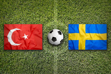 Image showing Turkey vs. Sweden flags on soccer field