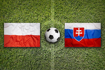 Image showing Poland vs. Slovakia flags on soccer field