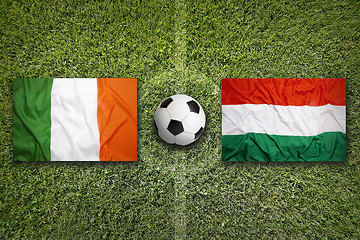 Image showing Ireland vs. Hungary flags on soccer field