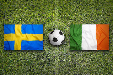 Image showing Sweden vs. Ireland flags on soccer field