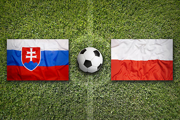 Image showing Slovakia vs. Poland flags on soccer field