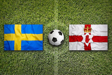 Image showing Sweden vs. Northern Ireland flags on soccer field
