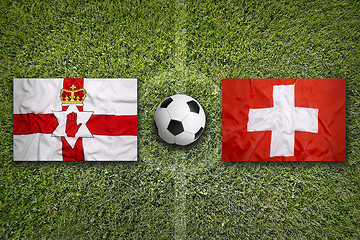 Image showing Northern Ireland vs. Switzerland flags on soccer field