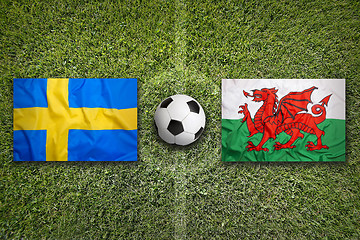 Image showing Sweden vs. Wales flags on soccer field