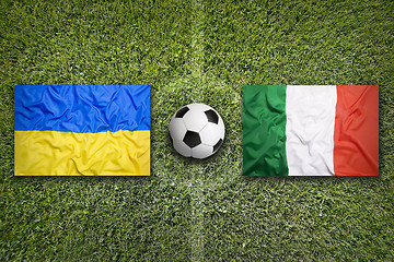 Image showing Ukraine vs. Italia flags on soccer field