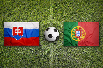 Image showing Slovakia vs. Portugal flags on soccer field