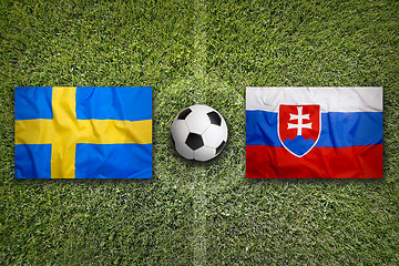 Image showing Sweden vs. Slovakia flags on soccer field