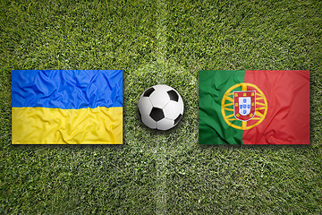 Image showing Ukraine vs. Portugal flags on soccer field
