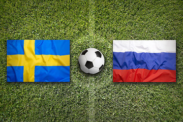 Image showing Sweden vs. Russia flags on soccer field