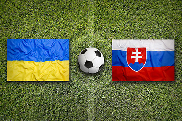 Image showing Ukraine vs. Slovakia flags on soccer field