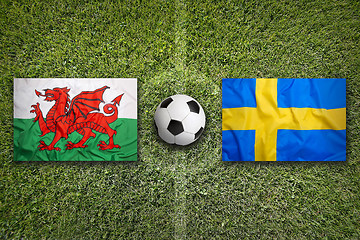 Image showing Wales vs. Sweden flags on soccer field