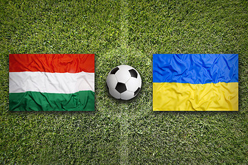 Image showing Hungary vs. Ukraine flags on soccer field