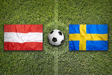 Image showing Austria vs. Sweden flags on soccer field