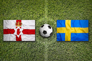 Image showing Northern Ireland vs. Sweden flags on soccer field