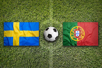 Image showing Sweden vs. Portugal flags on soccer field