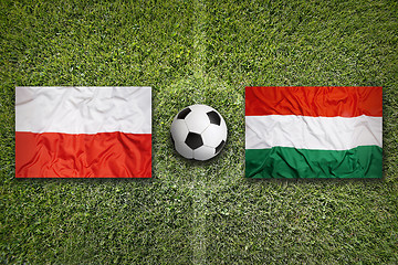 Image showing Poland vs. Hungary flags on soccer field